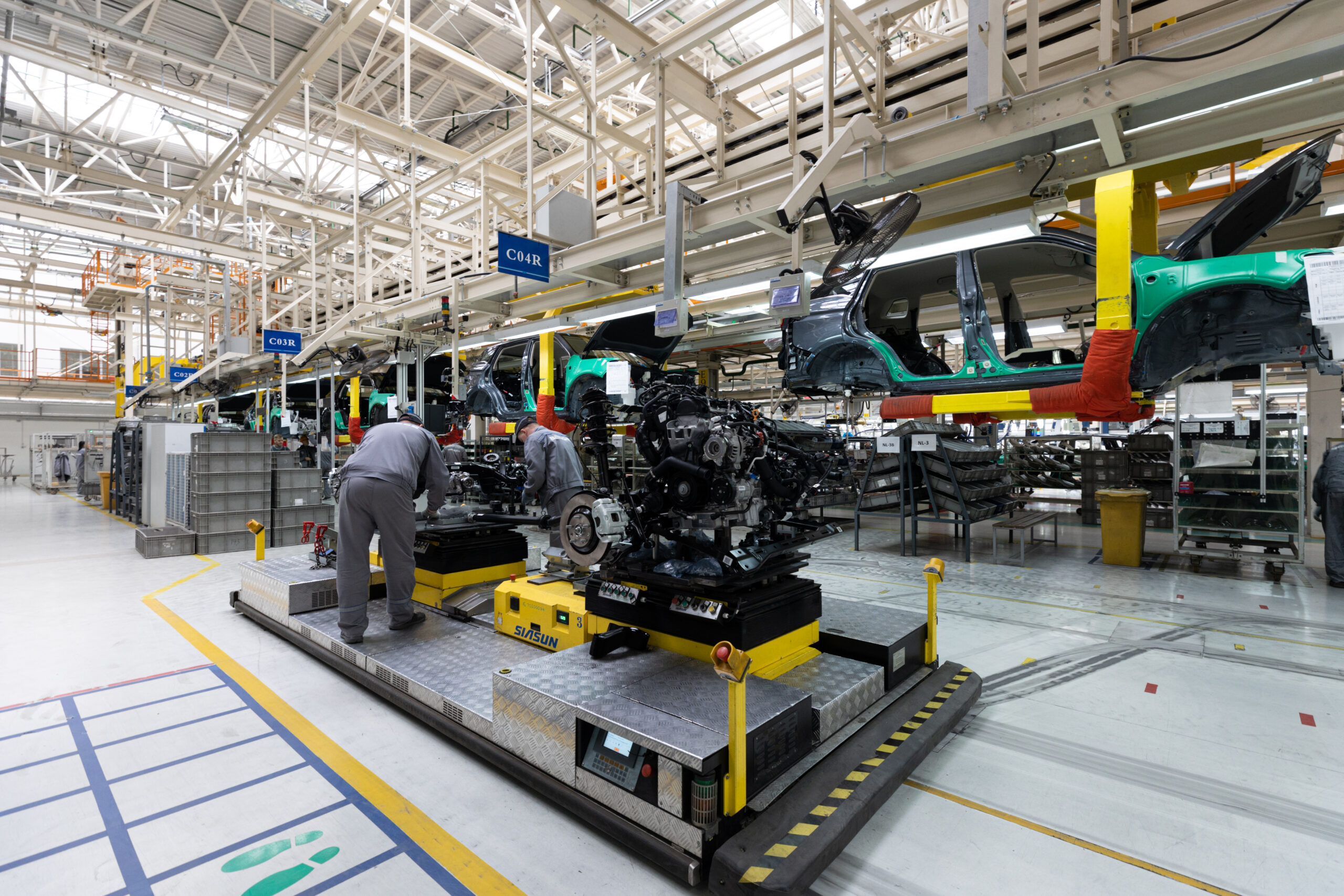 Photo of car bodies are on assembly line. Factory for production of cars. Modern automotive industry Photo of car bodies are on assembly line. Factory for production of cars. Modern automotive industry.