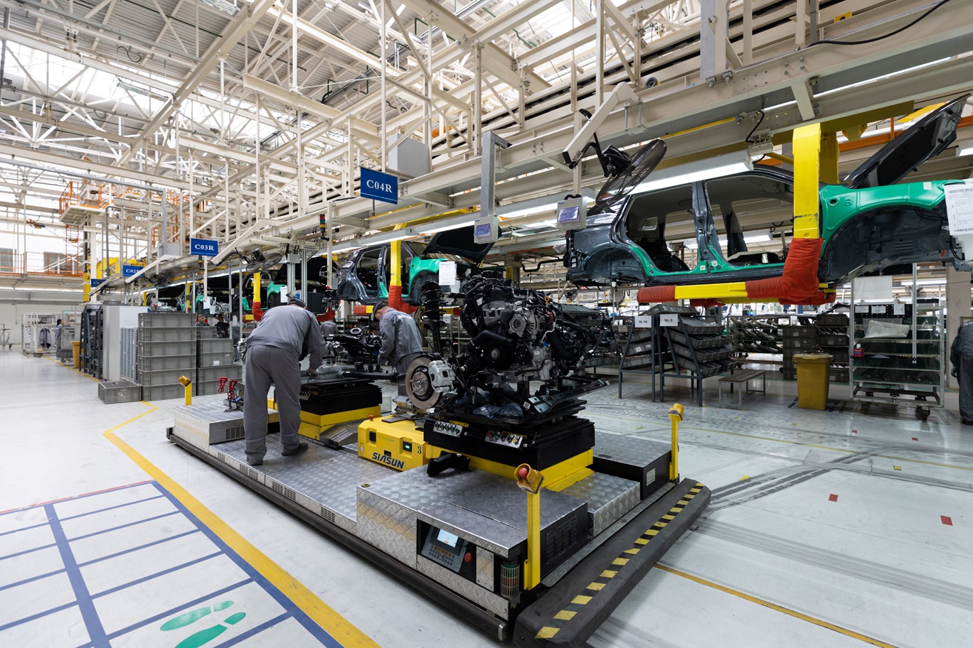 Photo of car bodies are on assembly line. Factory for production of cars. Modern automotive industry Photo of car bodies are on assembly line. Factory for production of cars. Modern automotive industry.